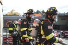Northshore Firefighters wearing oxygen tanks during training