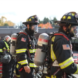 Northshore Firefighters wearing oxygen tanks during training
