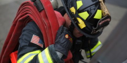 Northshore Firefighter carrying hose on shoulder