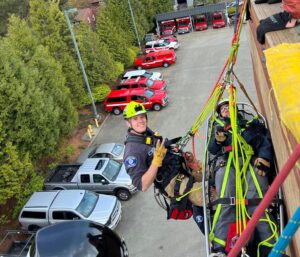 Firefighter dangling from building during training