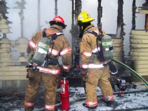 Two Firefighters extinguishing fire