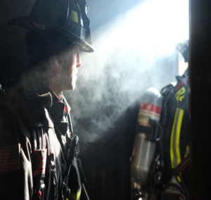 Firefighter looking through smoke