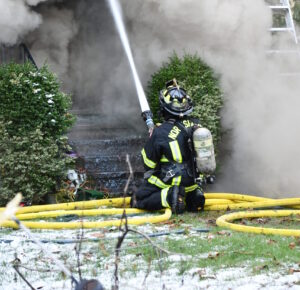 Firefighter spraying hose
