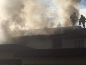 Firefighters on smokey roof