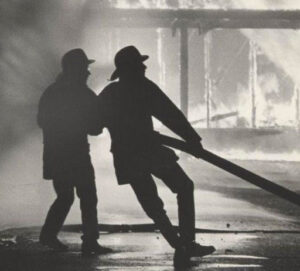 Two Firefighters pulling fire hose
