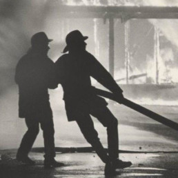 Two Firefighters pulling fire hose