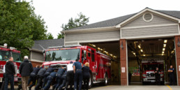Fire crew pushing engine into garage