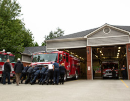 Fire crew pushing engine into garage
